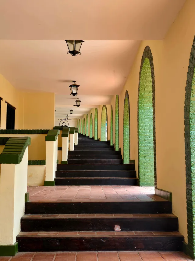 An arched corridor running along the guest rooms