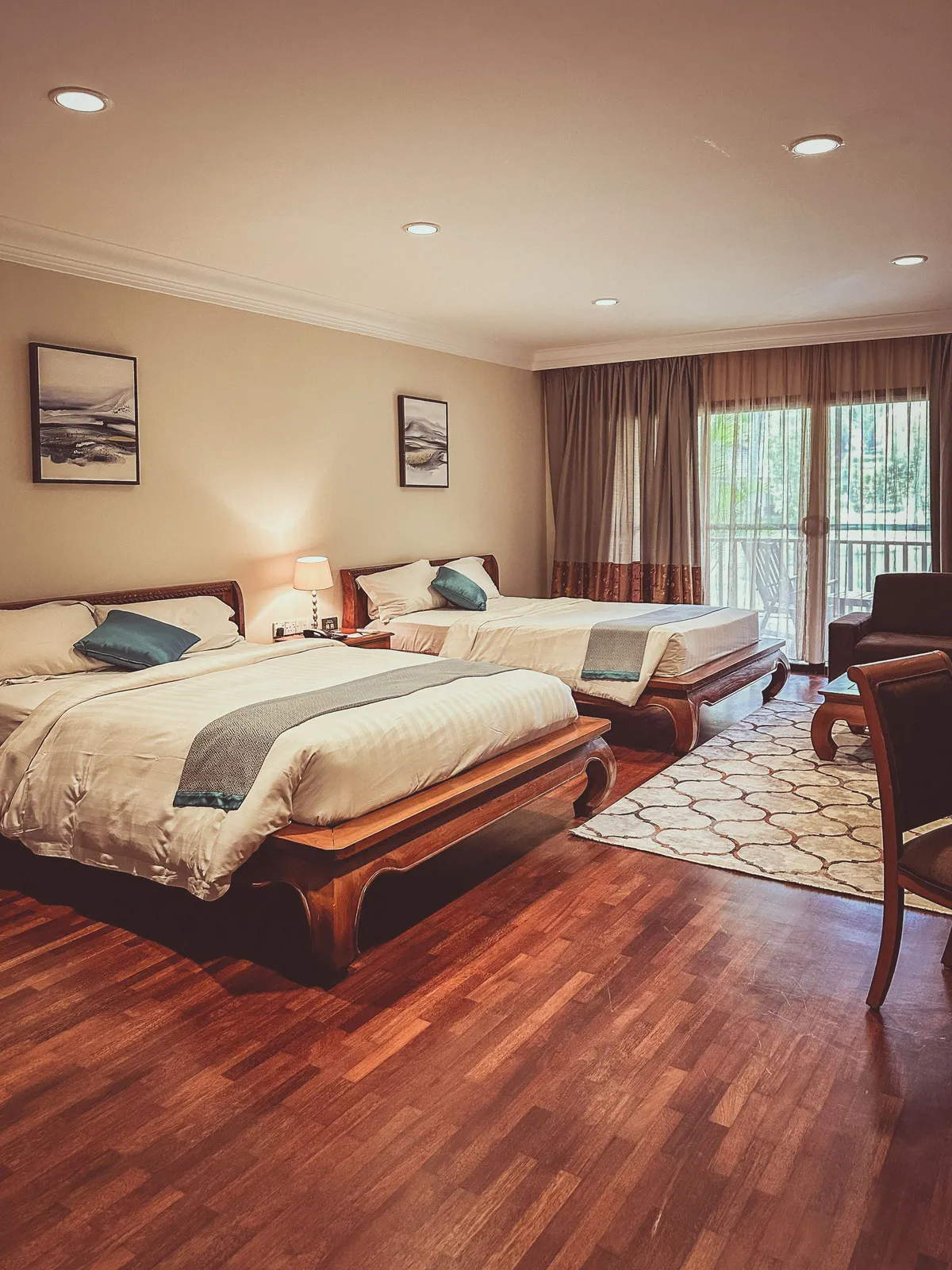 A four-bed family suite with two large beds and a balcony door