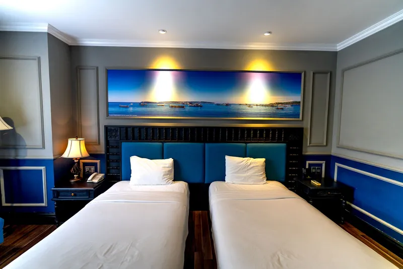 An air-conditioned two-bed room with a double bed